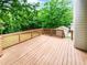 A spacious wooden deck overlooking a lush green backyard is ideal for relaxing and outdoor entertaining at 527 Tomahawk Trl, Woodstock, GA 30188