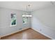 Cozy dining room with hardwood floors and a stylish chandelier at 527 Tomahawk Trl, Woodstock, GA 30188