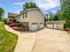 Well-maintained home featuring a large driveway, two-car garage, and lush landscaping at 527 Tomahawk Trl, Woodstock, GA 30188