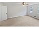 Simple but spacious bedroom featuring neutral colors and two windows at 527 Tomahawk Trl, Woodstock, GA 30188