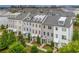 Spacious townhomes featuring a blend of brick and siding, with manicured greenery at 10200 Windalier Way, Roswell, GA 30076