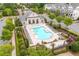 An aerial view of a neighborhood pool surrounded by lush landscaping and lounge chairs at 10200 Windalier Way, Roswell, GA 30076