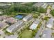 Aerial view showcasing the neighborhood with a pool, tennis court, and surrounding landscaping at 10200 Windalier Way, Roswell, GA 30076