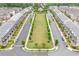 Aerial view of a Primary-planned community featuring townhomes, green spaces, and well-maintained streets at 10200 Windalier Way, Roswell, GA 30076