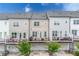 Contemporary townhomes with private balconies, rear garages, and modern architectural design at 10200 Windalier Way, Roswell, GA 30076