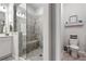 Bathroom with a gray tiled shower and separate toilet area, and a modern vanity at 10200 Windalier Way, Roswell, GA 30076