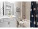 Bathroom featuring a vanity, toilet, and a shower-tub combination with a patterned curtain at 10200 Windalier Way, Roswell, GA 30076