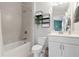 Bathroom featuring a tub-shower combo with tile surround, vanity and toilet at 10200 Windalier Way, Roswell, GA 30076