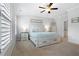 Cozy primary bedroom featuring plush carpeting, neutral decor, ceiling fan, and natural light at 10200 Windalier Way, Roswell, GA 30076