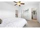 Bright bedroom with white comforter, fan, and a bathroom at 10200 Windalier Way, Roswell, GA 30076