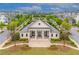 A stunning view of the Harlow Hall clubhouse with manicured lawns, landscaping, and charming architectural details at 10200 Windalier Way, Roswell, GA 30076