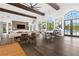 Spacious common room featuring a pool view, exposed beams, hardwood floors, and modern decor at 10200 Windalier Way, Roswell, GA 30076