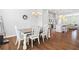 Dining room with white table and chairs is adjacent to the kitchen and living room at 10200 Windalier Way, Roswell, GA 30076