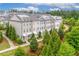 Exterior shot of townhomes surrounded by lush trees and landscaping creating an inviting community ambiance at 10200 Windalier Way, Roswell, GA 30076