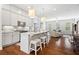 Open-concept kitchen boasts stainless steel appliances, granite countertops, and a cozy breakfast bar perfect for entertaining at 10200 Windalier Way, Roswell, GA 30076