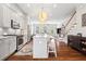 Stylish open-concept kitchen with island seating, hardwood floors, and views of the living area at 10200 Windalier Way, Roswell, GA 30076