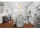 Contemporary kitchen featuring a spacious island, stainless steel appliances, and hardwood floors at 10200 Windalier Way, Roswell, GA 30076