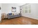 Cozy living room with hardwood floors, grey sofa, and plantation shutters at 10200 Windalier Way, Roswell, GA 30076