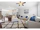 Spacious living room with cozy seating, bright windows, and an open layout into the kitchen and dining area at 10200 Windalier Way, Roswell, GA 30076