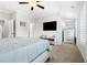 Spacious main bedroom with a large bed, TV, walk in closet and plantation shutters at 10200 Windalier Way, Roswell, GA 30076