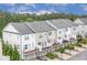 New townhomes featuring private balconies, rear garages, and modern exterior finishes at 10200 Windalier Way, Roswell, GA 30076