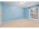 Bright bedroom with neutral carpet, blue walls and large window at 3135 Seven Pines Ct # 101, Atlanta, GA 30339
