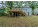 Expansive backyard view featuring a raised wooden deck and lush green surroundings at 3140 Delowe Dr, Atlanta, GA 30344