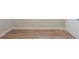 Empty bedroom with hardwood flooring, neutral paint, base trim, and a white door at 3140 Delowe Dr, Atlanta, GA 30344