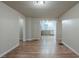 Open dining room with wood floors leading to a kitchen with stainless steel appliances at 3140 Delowe Dr, Atlanta, GA 30344