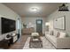 Cozy living room with hardwood floors, neutral colors, stylish furniture, and a modern entertainment center at 3140 Delowe Dr, Atlanta, GA 30344