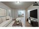 Bright living room with a view of the kitchen, featuring a comfortable couch and stylish decor at 3140 Delowe Dr, Atlanta, GA 30344