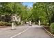 Gated community entrance with brick pillars and lush greenery, offering security and curb appeal at 3472 Essex Ave # 81, Atlanta, GA 30339