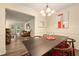 View of the dining room with a black table, red chairs, modern artwork, and an open layout to the living room at 3472 Essex Ave # 81, Atlanta, GA 30339