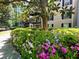 Exterior view of building surrounded by flowering shrubs and mature trees at 3472 Essex Ave # 81, Atlanta, GA 30339