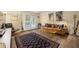 Bright living room with neutral walls, a brown leather couch, and a patterned rug over the hardwood floors at 3472 Essex Ave # 81, Atlanta, GA 30339