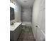 A light and bright bathroom with gray tile flooring and a shower/tub combination at 4011 Redan Rd # 8, Stone Mountain, GA 30083
