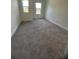A bright bedroom with two windows and soft gray carpet flooring at 4011 Redan Rd # 8, Stone Mountain, GA 30083