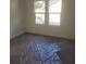 Bright, empty bedroom with natural light shining through the double windows at 4011 Redan Rd # 8, Stone Mountain, GA 30083