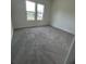 A bright bedroom with two windows and soft gray carpet flooring at 4011 Redan Rd # 8, Stone Mountain, GA 30083