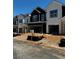 Townhomes under construction, showcasing farmhouse-style architecture with a mix of dark and white siding at 4011 Redan Rd # 8, Stone Mountain, GA 30083