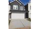 Two-story home with a gray exterior and white garage door at 4011 Redan Rd # 8, Stone Mountain, GA 30083