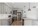 Well-lit kitchen featuring stainless steel appliances, gray cabinetry, granite countertops, and a kitchen island at 4011 Redan Rd # 8, Stone Mountain, GA 30083