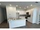 Modern kitchen features an island with quartz countertops, white cabinets, and stainless steel appliances at 4011 Redan Rd # 8, Stone Mountain, GA 30083