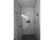 A shower stall with black and white tiled walls at 4011 Redan Rd # 8, Stone Mountain, GA 30083