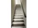 Staircase with wooden handrail and covered steps, leading to the upper level at 4011 Redan Rd # 8, Stone Mountain, GA 30083