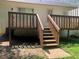 A well-kept back deck with a set of stairs leading to a concrete path, a perfect place for outdoor relaxation at 1047 Plantation Way, Kennesaw, GA 30301