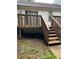 Backyard exterior shot of a home featuring a wooden deck and staircase to the lawn at 1047 Plantation Way, Kennesaw, GA 30301