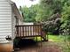 Backyard exterior shot of a home featuring a wooden deck and stairs to the lawn at 1047 Plantation Way, Kennesaw, GA 30301