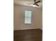 Bedroom features hardwood floors, a ceiling fan, and a large window with horizontal blinds at 1047 Plantation Way, Kennesaw, GA 30301
