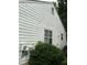 Exterior view of a home featuring vinyl siding, multiple windows, and utilities at 1047 Plantation Way, Kennesaw, GA 30301